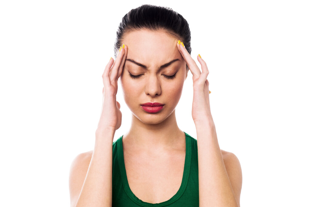 Woman applying gentle pressure on temple of her head