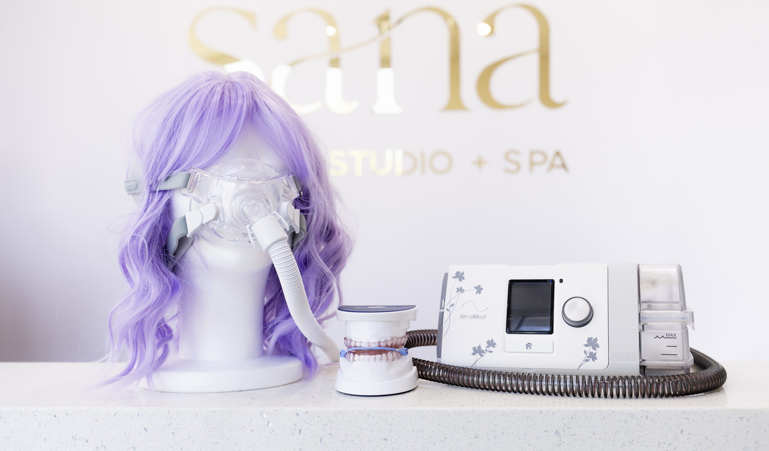 Sleep Apnea machine on a mannequin head with purple hair